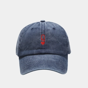 Detailed close-up of navy washed cotton baseball cap featuring red Q embroidery