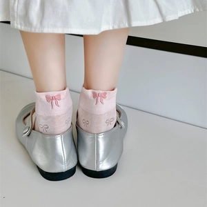 Close-up of pink bow embroidery on sweet style cotton ankle socks with Mary Jane shoes