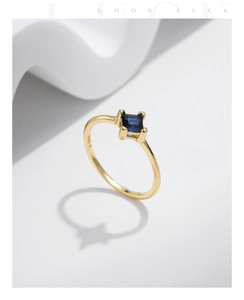 Macro shot of S925 silver gold-plated ring with square blue stone and S925 engraving