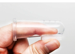 Detailed view of clear silicone finger toothbrush for pets with soft bristles and massager