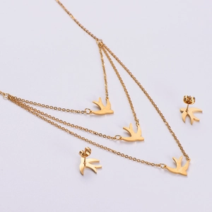 Vintage gold swallow pendant necklace and earring set with textured metallic finish