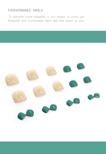 Detail view of 24pcs press-on toenails featuring dark green and floral patterns