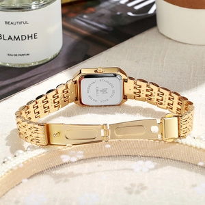 Detailed back view of gold square watch with stainless steel mesh strap and fold clasp