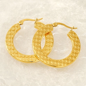 Golden stainless steel hoop earrings with embossed star pattern for a vintage look