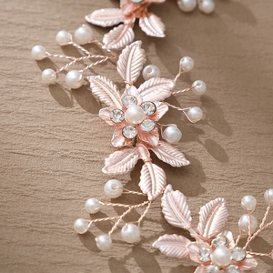 Detailed close-up of rose gold leaf hairband with pearls and rhinestones for bridal styling