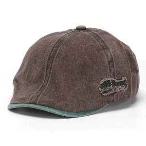 Detail of vintage washed denim newsboy hat in brown with green contrast stitching
