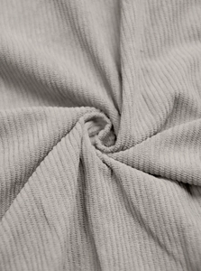 Detailed macro view of gray corduroy fabric texture showing soft vertical ribs and texture