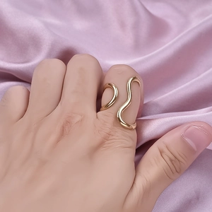 Minimalist gold wave curved line open ring made of 304 stainless steel on silk fabric