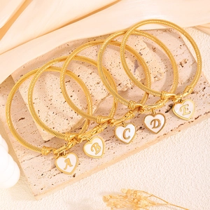 Elegant gold titanium steel rope bracelets with heart letter charms on beige stone