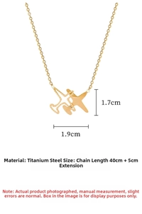 Detail of gold airplane pendant in titanium steel with engraved Plane text and O-chain