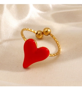 Detail of red heart enamel ring with textured golden band and adjustable open design