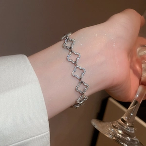 Detailed view of silver 18k gold plated gourd charm bracelet with sparkling zircons on wrist