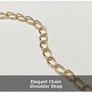 Close-up of a polished golden metal chain strap on a white wood texture surface
