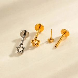 Titanium piercing jewelry featuring gold and silver five-bead flower threadless labrets