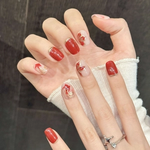 Red and gold koi fish nail art with gradient design and intricate floral patterns