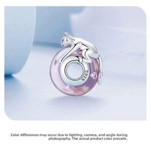 Macro detail of S925 sterling silver cat charm with pink glass bead for bracelets