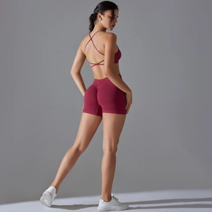 Detail of wine red seamless sports set featuring cross back straps and scrunch butt shorts