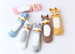 Detail of six colorful cartoon coral fleece cat socks with bells for indoor home wear