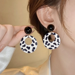 Chic black and white leopard print hollow circle drop earrings worn by a model
