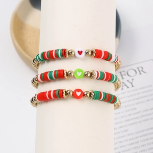 Three-piece Christmas beaded bracelet set with red, white, and green heishi heart beads