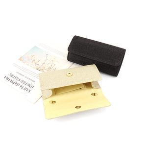 Chic glitter evening clutch bag in black and gold with chain strap on white background