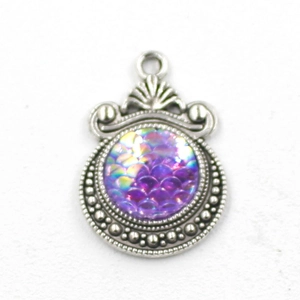 Macro view of 12mm silver mermaid scale pendant charm with iridescent purple finish