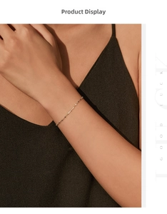 Close-up of a delicate golden S925 sterling silver chain bracelet worn on a woman's wrist