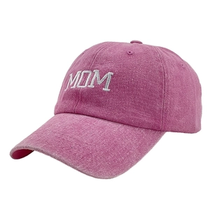 Close-up of pink washed cotton baseball cap with white MOM embroidery and vintage texture