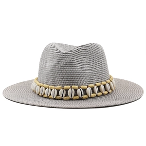 Grey woven straw Panama hat with wood beads and shell band on white background