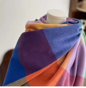 Detailed view of colorful oversized checkered scarf draped on a female mannequin bust