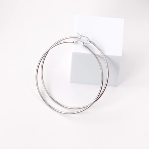 Detail view of large 2mm stainless steel hoop earrings on a white minimalist background
