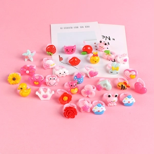 Pink assorted plastic rings for girls with cartoon strawberry duck and crown patterns