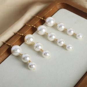 Elegant French style gold titanium earrings with dangling white gradient pearls