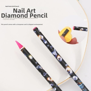 Detail of black nail rhinestone wax pen with pink tip and yellow heart-shaped sharpener