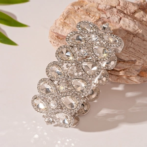 Macro detail of silver stretch bracelet featuring large teardrop-shaped clear crystals