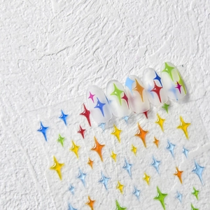 Detailed view of colorful star nail art stickers with embossed 3D texture on clear tips