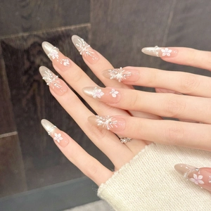 Handmade orange cherry blossom press-on nails with 3D flowers and pearls on long almond shape