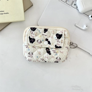 Close-up of a quilted cream organizer bag with cute cat prints and a metal zipper hook