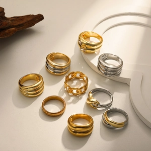 Set of eight two-tone 18K gold and silver rings with diverse textured woven designs