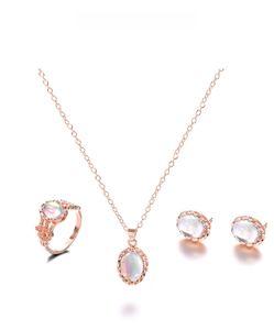 Close-up of rose gold jewelry set with oval stones and vintage hollow patterns