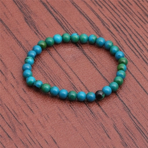 Macro detail of Phoenix Lapis Lazuli beaded bracelet on a dark wood texture surface