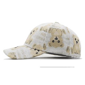 Detail shot of light grey baseball cap featuring cute embroidered bear patterns
