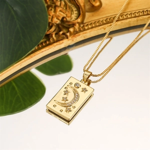 Macro shot of gold celestial necklace with crescent moon and star zircon details