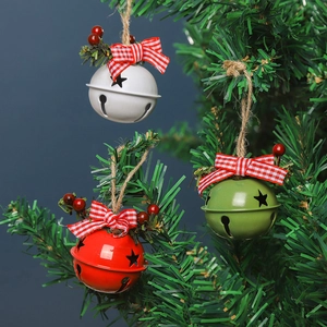 Christmas bells ornaments with plaid bows and star cutouts on tree branch