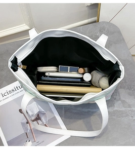 Top view of white tote bag showing spacious interior with books and umbrella