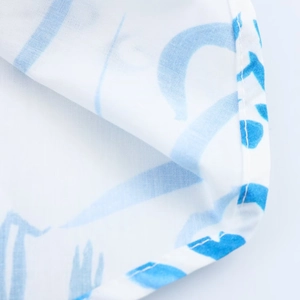 Detailed macro view of white and blue printed fabric texture with high quality stitching