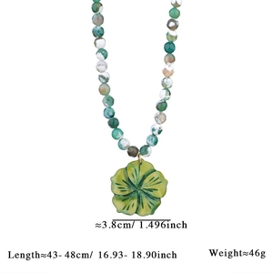 Detail view of colorful beaded necklace with green flower pendant and size dimensions