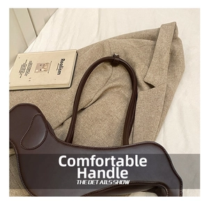 Detail shot of a dark brown dachshund-shaped tote bag on an oversized khaki blazer