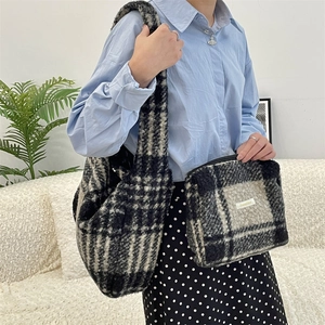 Detail of checkered plush tote bag and matching pouch with soft wool fabric texture