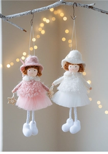 Detailed view of plush angel dolls with tulle skirts and festive gold accessories